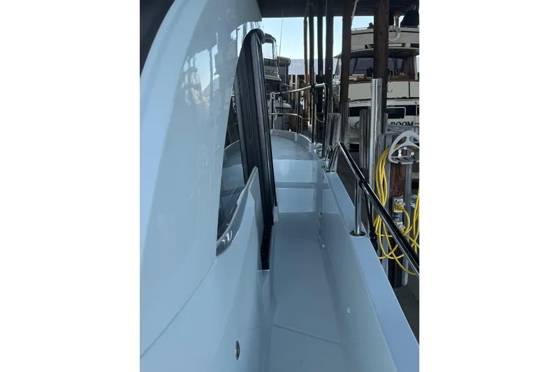 Slide: The Image of 2025 Beneteau Antares 11 Fly yacht side deck with railing and dock view. - 52