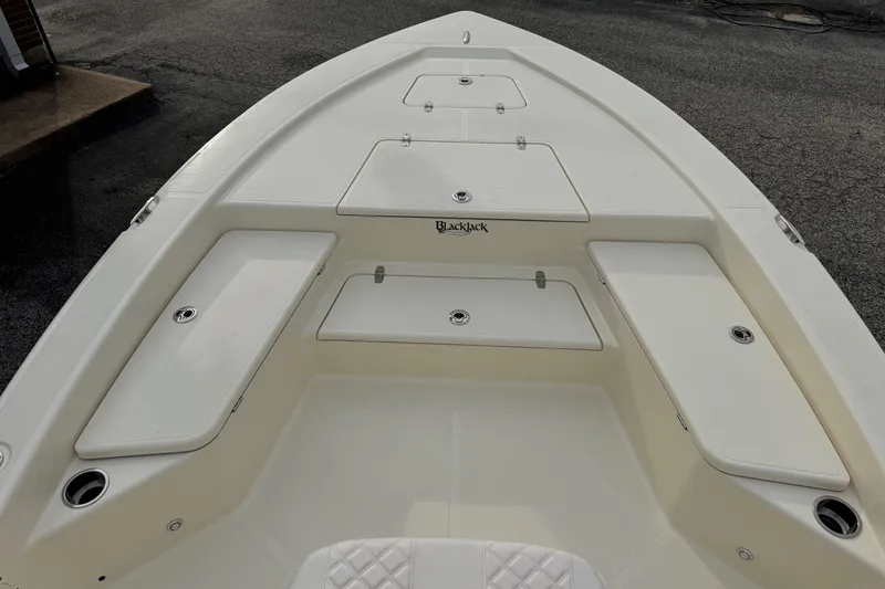 Slide: The Image of 2026 BlackJack 224 boat deck with storage compartments and sleek design. - 10