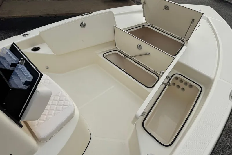 Slide: The Image of Open storage compartments on a 2026 BlackJack 224 boat, showcasing spacious interior design. - 11