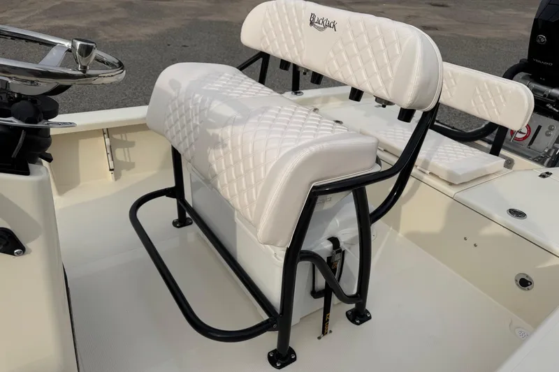 Slide: The Image of White cushioned seating on 2026 BlackJack 224 boat, featuring sleek black frame design. - 16