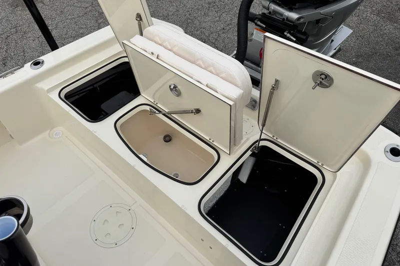 Slide: The Image of Open storage compartments on a 2026 BlackJack 224 boat deck. - 18
