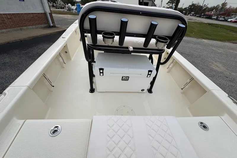 Slide: The Image of 2026 BlackJack 224 boat interior with seating, rod holders, and cooler on deck. - 20