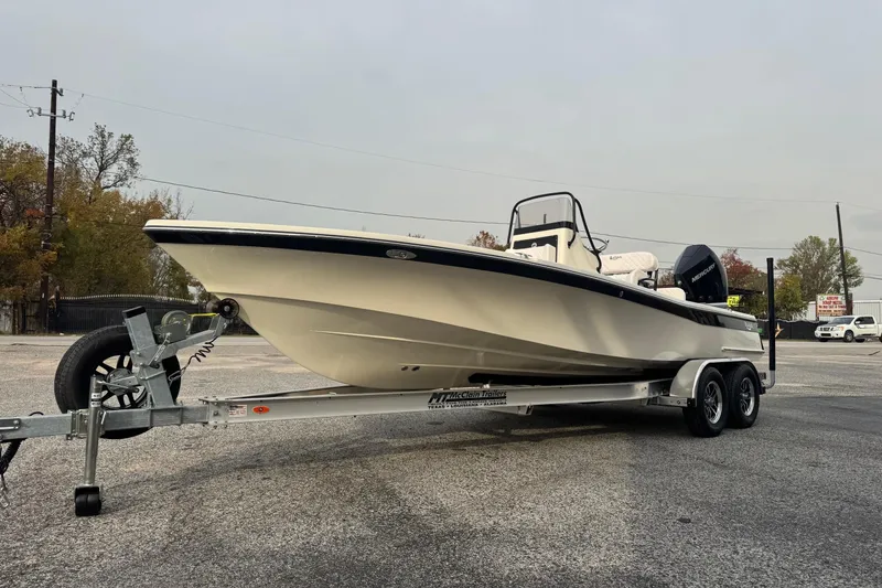 Slide: The Image of 2026 BlackJack 224 boat on trailer, parked outdoors, showcasing sleek design and modern features. - 5