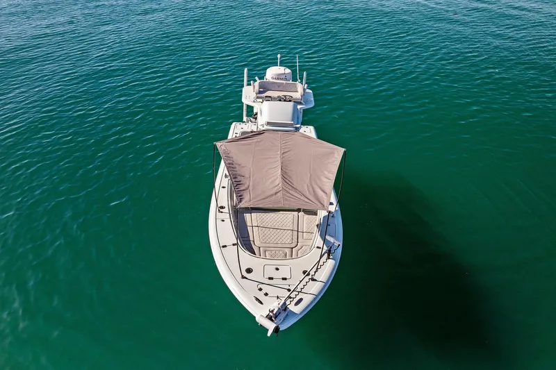 Slide: The Image of 2023 Barker Boatworks 26 Open on clear blue water, aerial view. - 12
