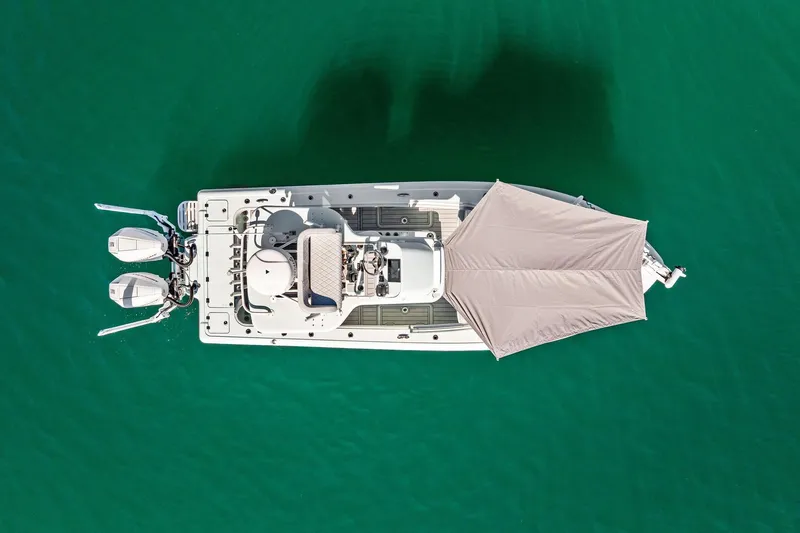 Slide: The Image of Aerial view of 2023 Barker Boatworks 26 Open on turquoise water. - 13