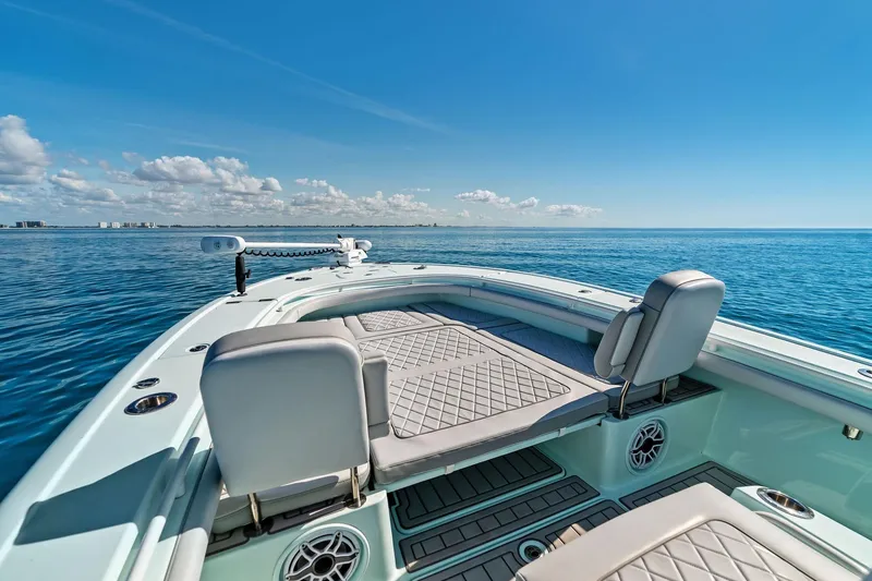 Slide: The Image of 2023 Barker Boatworks 26 Open on calm ocean, featuring spacious deck and seating. - 17