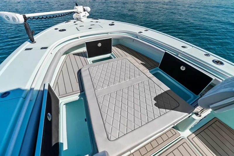 Slide: The Image of 2023 Barker Boatworks 26 Open, spacious deck with storage, on calm blue water. - 18