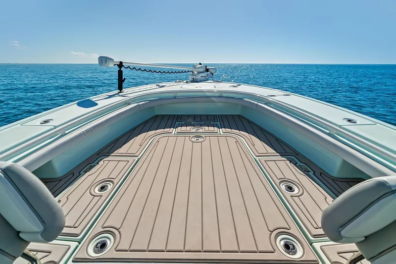 Slide: The Image of 2023 Barker Boatworks 26 Open on calm ocean, showcasing spacious deck and sleek design. - 19