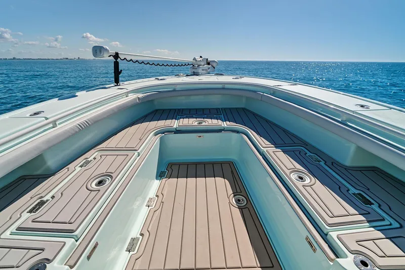 Slide: The Image of 2023 Barker Boatworks 26 Open on calm ocean, showcasing spacious deck and storage compartments. - 20