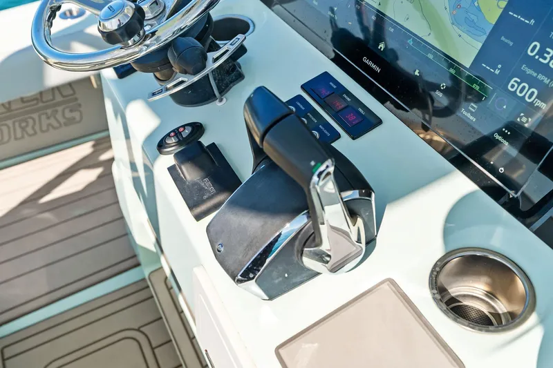 Slide: The Image of 2023 Barker Boatworks 26 Open helm with modern controls and Garmin display. - 30