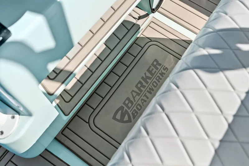 Slide: The Image of 2023 Barker Boatworks 26 Open interior with logo and quilted seating. - 33