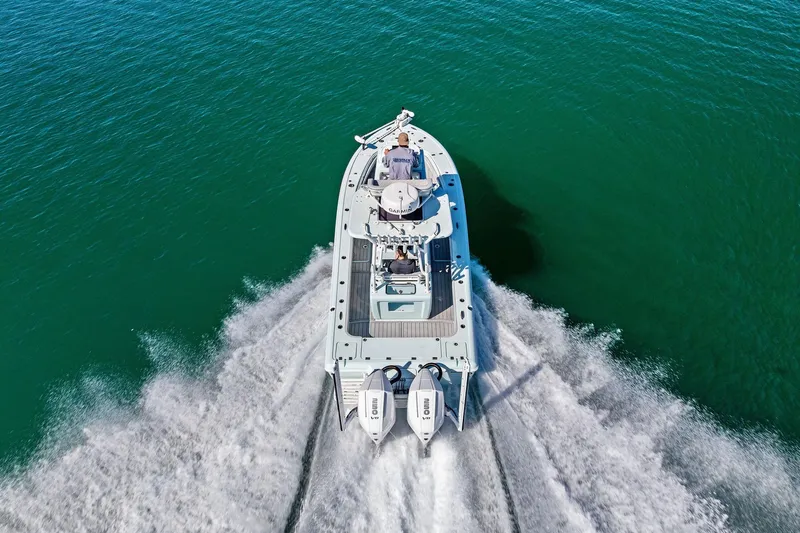 Slide: The Image of 2023 Barker Boatworks 26 Open cruising on clear blue water, aerial view. - 41