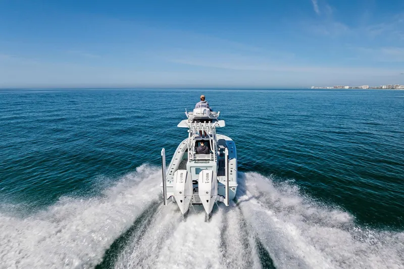 Slide: The Image of 2023 Barker Boatworks 26 Open cruising on open water, clear blue sky. - 42