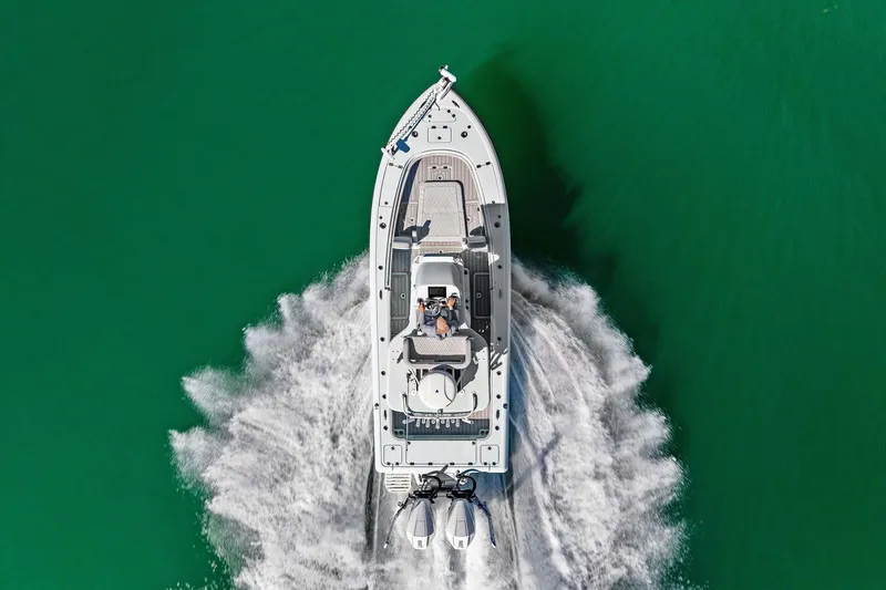 Slide: The Image of 2023 Barker Boatworks 26 Open cruising on vibrant green water, aerial view. - 44