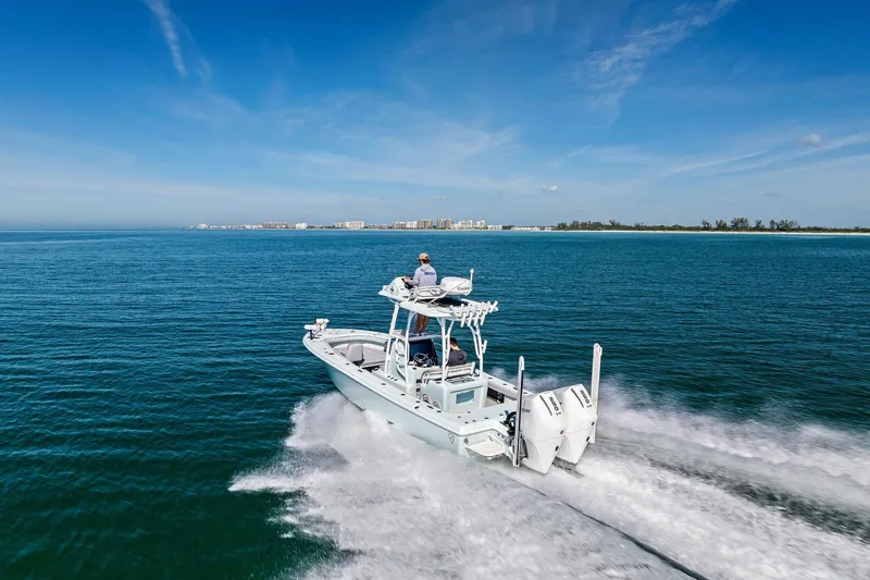 Slide: The Image of 2023 Barker Boatworks 26 Open cruising on open water under clear blue skies. - 45