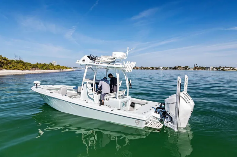 Slide: The Image of 2023 Barker Boatworks 26 Open on calm water near a scenic shoreline. - 5