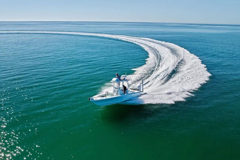 Slide: The Image of 2023 Barker Boatworks 26 Open cruising on clear blue water, leaving a curved wake. - 55