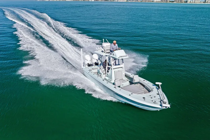 Slide: The Image of 2023 Barker Boatworks 26 Open cruising on clear blue water, showcasing speed and elegance. - 56