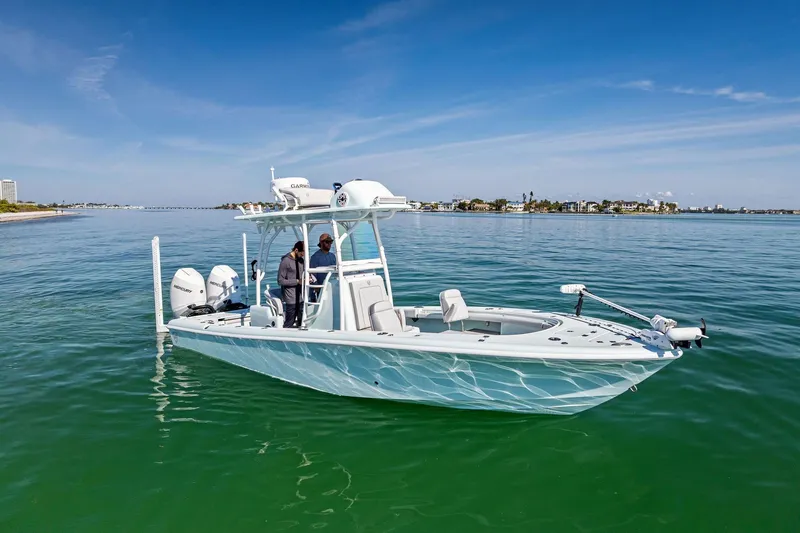 Slide: The Image of 2023 Barker Boatworks 26 Open on calm water, featuring dual engines and modern design. - 6