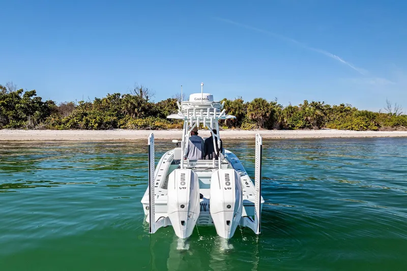 Slide: The Image of 2023 Barker Boatworks 26 Open on water near a sandy shoreline. - 8