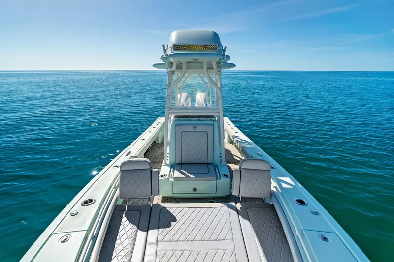 Slide: The Image of 2023 Barker Boatworks 26 Open on calm ocean waters, showcasing sleek design and seating. - 22