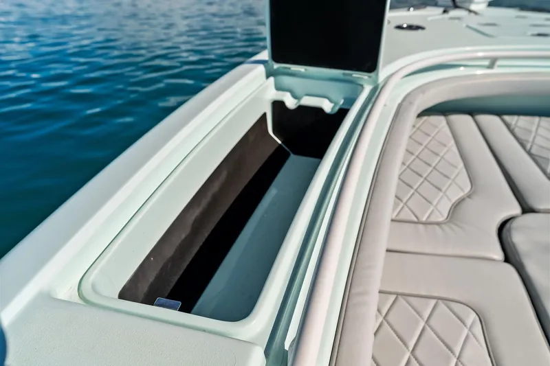 Slide: The Image of 2023 Barker Boatworks 26 Open interior with cushioned seating and storage compartment. - 23