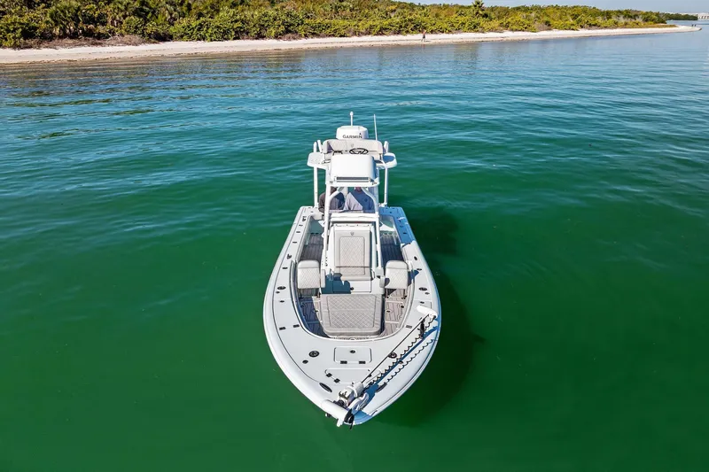 Slide: The Image of 2023 Barker Boatworks 26 Open on calm water near a sandy shoreline. - 3