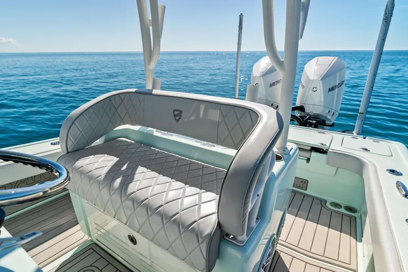 Slide: The Image of 2023 Barker Boatworks 26 Open, luxury seating, dual Mercury engines, on calm ocean waters. - 31