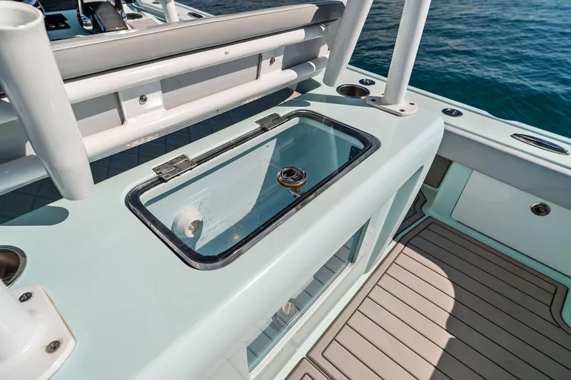 Slide: The Image of 2023 Barker Boatworks 26 Open, featuring a sleek livewell on deck. - 35