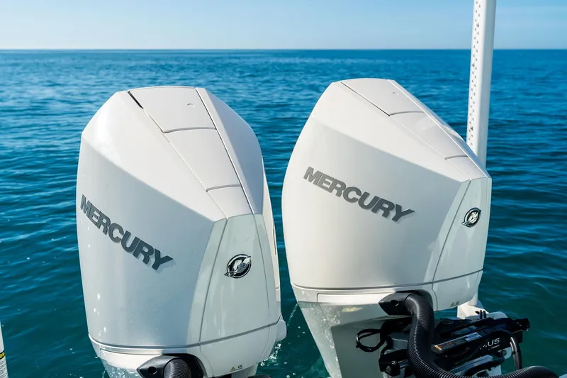 Slide: The Image of Twin Mercury outboard engines on a 2023 Barker Boatworks 26 Open, cruising on open water. - 39