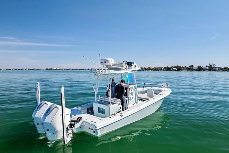Slide: The Image of 2023 Barker Boatworks 26 Open on calm water, featuring dual engines. - 4