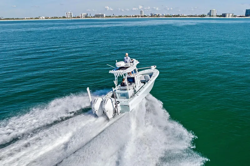 Slide: The Image of 2023 Barker Boatworks 26 Open cruising on open water, city skyline in background. - 47
