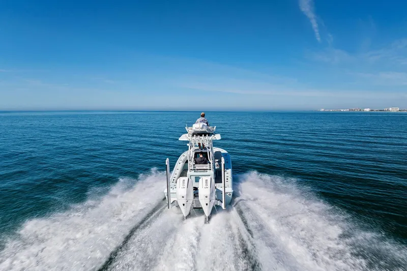Slide: The Image of 2023 Barker Boatworks 26 Open cruising on open water under clear blue sky. - 59
