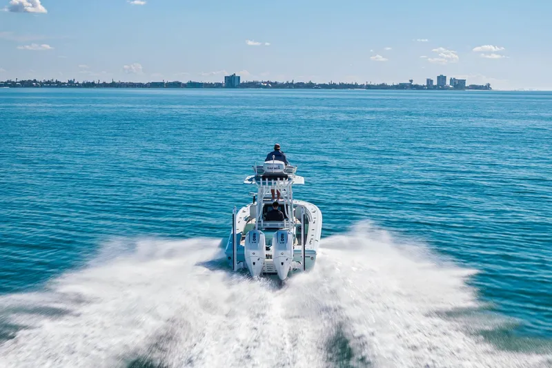 Slide: The Image of 2023 Barker Boatworks 26 Open cruising on open water, city skyline in background. - 64