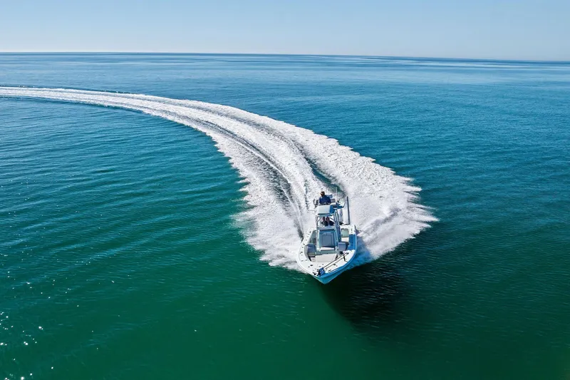 Slide: The Image of 2023 Barker Boatworks 26 Open cruising on open water, creating a dynamic wake. - 65