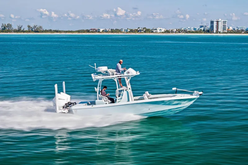 Slide: The Image of 2023 Barker Boatworks 26 Open cruising on clear blue water near a distant shoreline. - 66