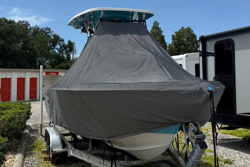 Slide: The Image of 2023 Key West 219 FS boat covered on trailer, outdoor storage setting. - 10