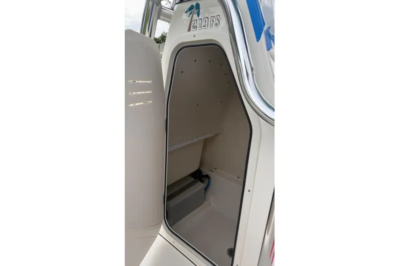 Slide: The Image of 2023 Key West 219 FS boat interior storage compartment, open and empty. - 15