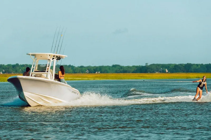 Slide: The Image of 2023 Key West 219 FS boat interior with cushioned seating and cup holders. - 19