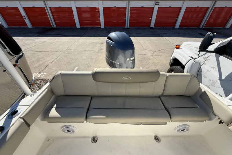 Slide: The Image of 2023 Key West 219 FS boat interior with seating and Yamaha 200 engine. - 28