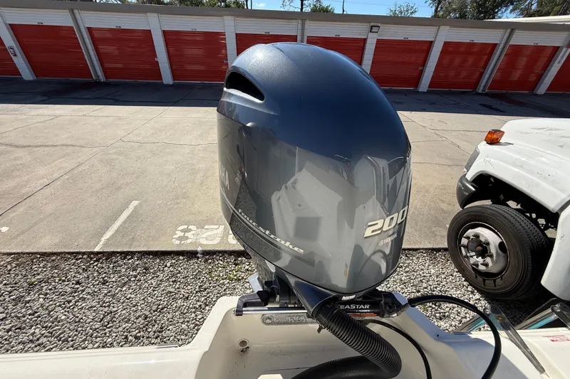 Slide: The Image of 2023 Key West 219 FS boat with Yamaha 200 outboard motor in storage area. - 29