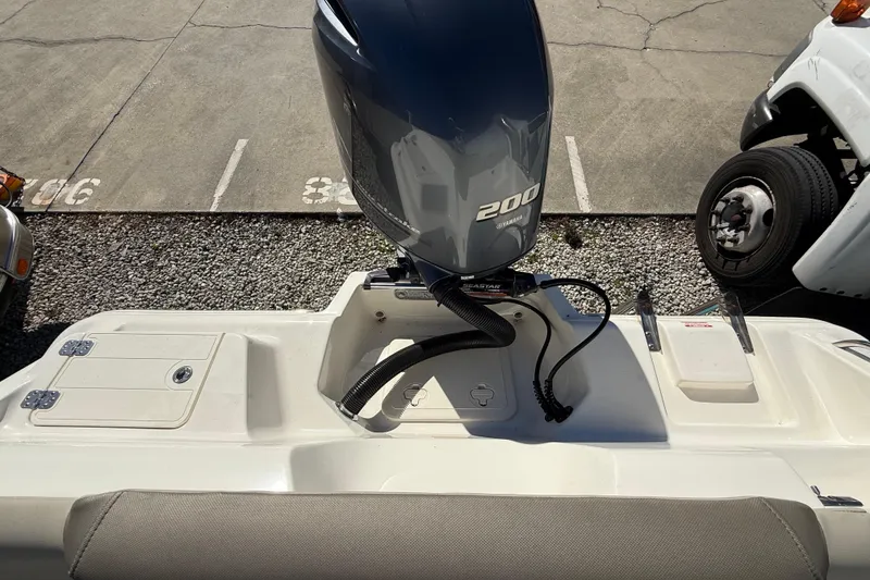 Slide: The Image of 2023 Key West 219 FS boat with Yamaha 200 engine in parking lot. - 31