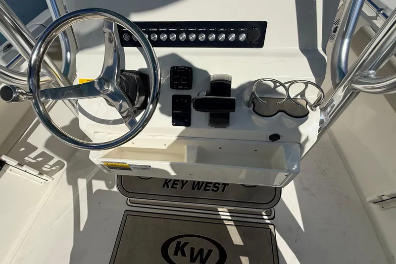 Slide: The Image of 2023 Key West 219 FS boat console with steering wheel and controls. - 34
