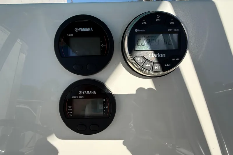 Slide: The Image of Yamaha gauges and Clarion stereo on 2023 Key West 219 FS boat dashboard. - 35
