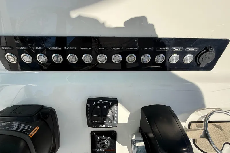 Slide: The Image of Control panel of 2023 Key West 219 FS boat with various switches and controls. - 36
