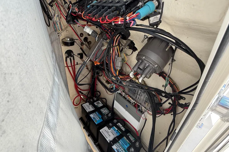 Slide: The Image of 2023 Key West 219 FS boat wiring and battery compartment, showcasing electrical components and connections. - 38