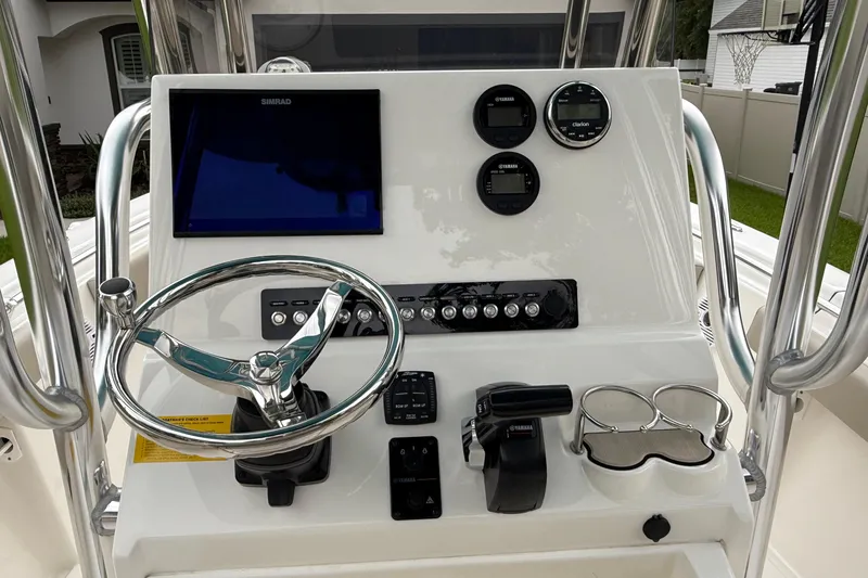 Slide: The Image of 2023 Key West 219 FS boat console with steering wheel, controls, and display screen. - 4