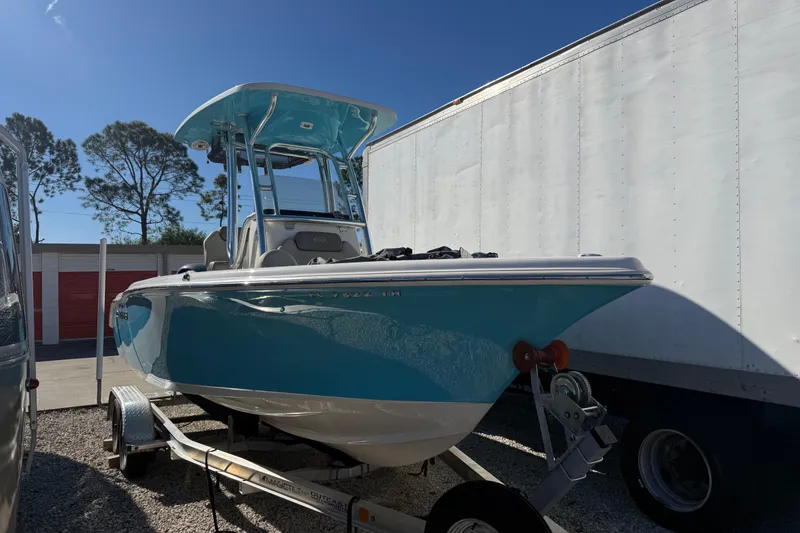 Slide: The Image of 2023 Key West 219 FS boat on trailer, parked outdoors under clear blue sky. - 42