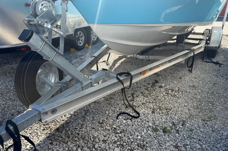 Slide: The Image of 2023 Key West 219 FS boat on trailer, parked on gravel surface. - 44