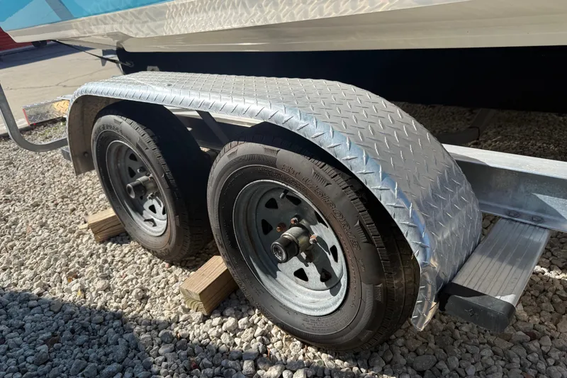 Slide: The Image of Trailer wheels of 2023 Key West 219 FS boat on gravel surface. - 48